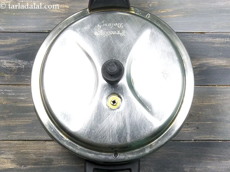 Step 23 – Close the lid of the pressure cooker and pressure cook for 4 whistles. Allow the …