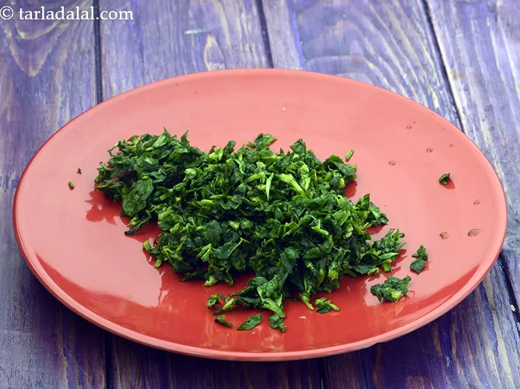 Step 6 – Squeeze the water from the fenugreek leaves and transfer the leaves in a deep bowl.