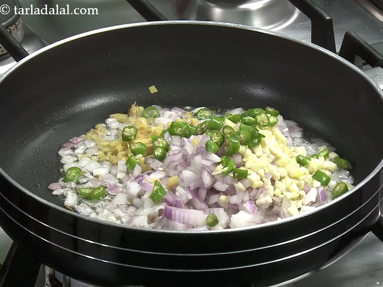 Step 32 – Add 1 tbsp&nbsp;<a href="https://www.tarladalal.com/glossary-chopped-green-chilli-820i">chopped green chillies</a>.