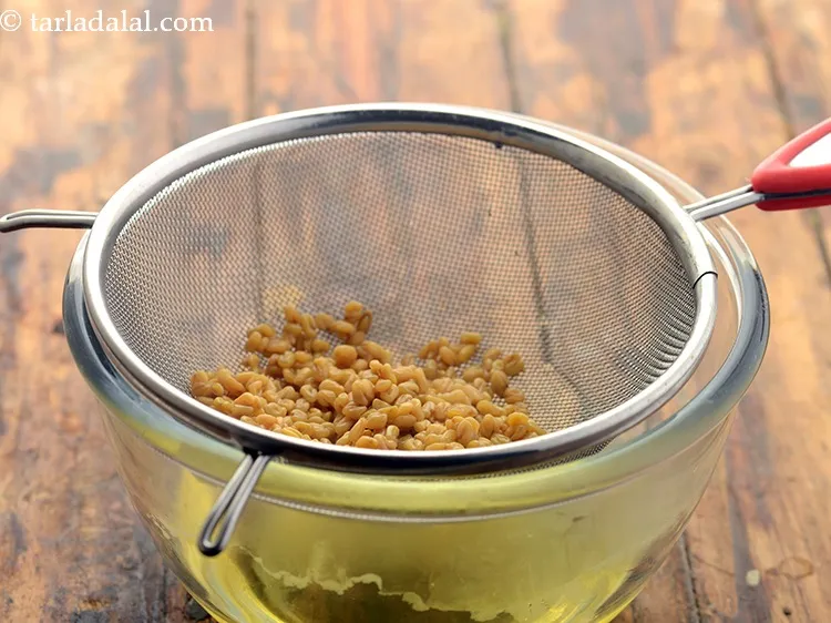 Step 2 – After half an hour, drain the methi seeds well.