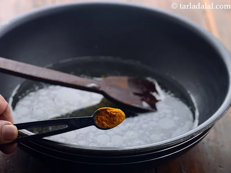 Step 8 – Add turmeric powder.