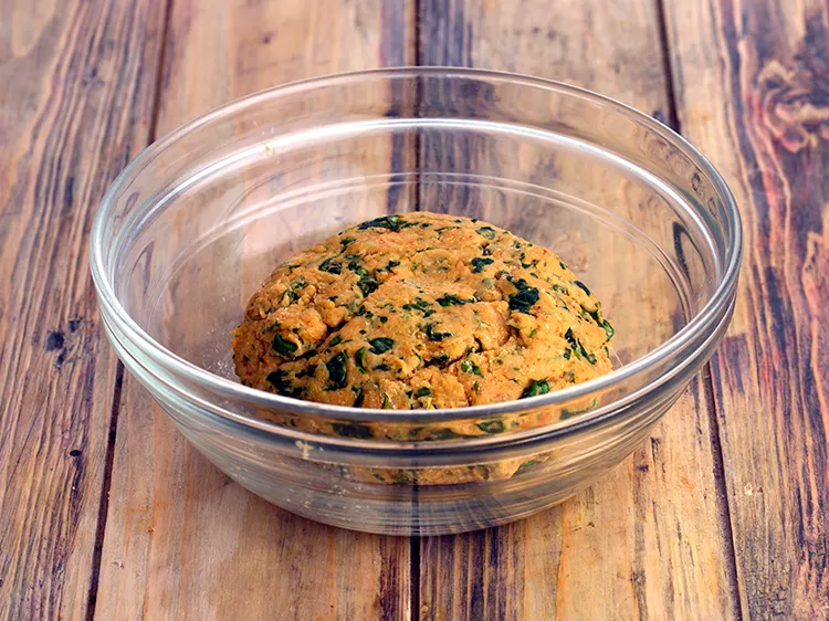 Step 9 – Add enough warm water and knead into a soft dough for <strong>methi ka paratha</strong>.