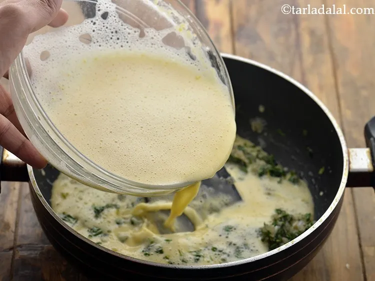 Step 13 – Add the prepared besan-water mixture.