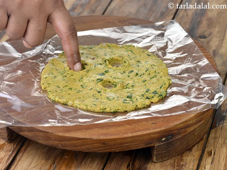 Step 6 – Make 3 holes on the rolled circle with the index finger. This helps the oil …