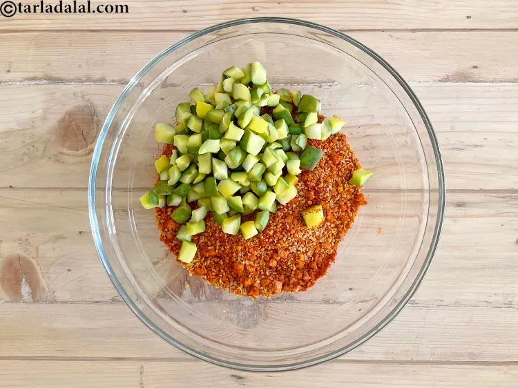 Step 23 – <meta charset="UTF-8" />Add the dried raw mango cubes to the prepared mixture .