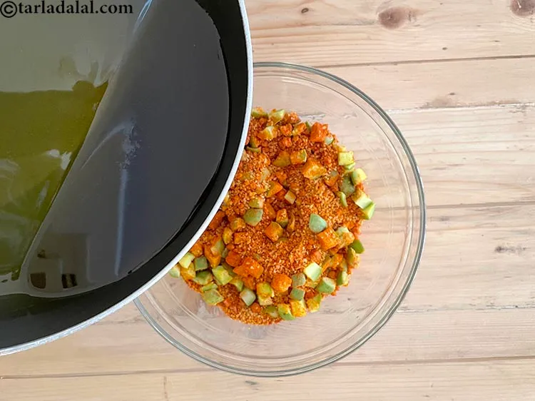 Step 25 – <meta charset="UTF-8" />Pour the mustard oil over the raw mango mixture.