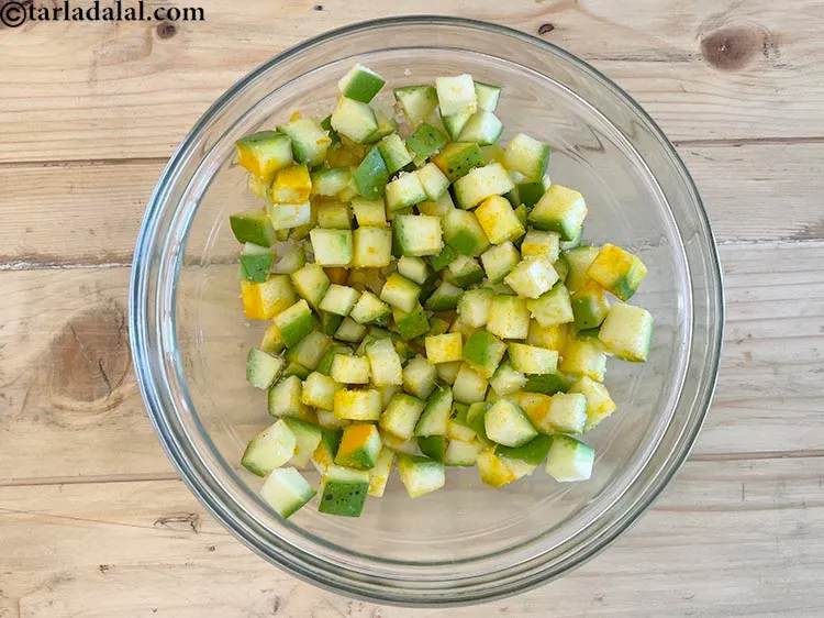 Step 9 – Mix well. Ensure that the haldi has coated all the raw mango cubes evenly.