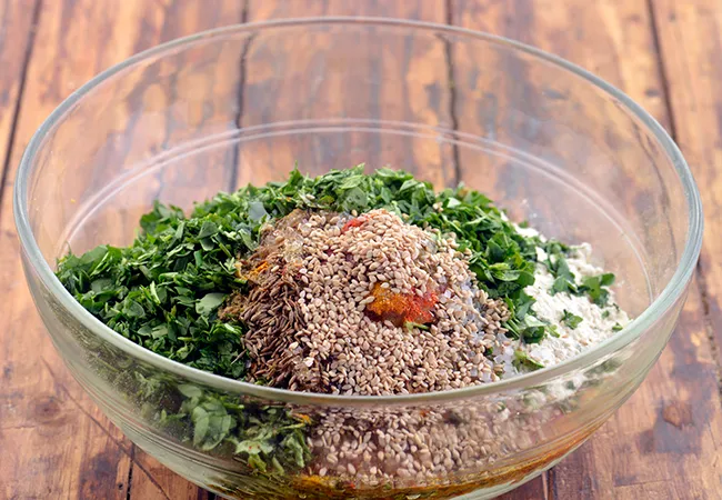 Step 14 – Add the sesame seeds (til). It gives a mild nutty flavour to the <strong>Methi Theplas.</strong>