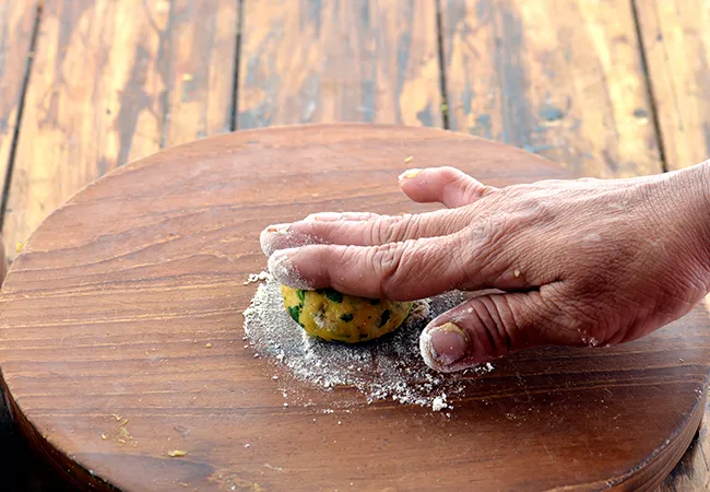 Step 21 – Take a portion of the dough and flatten it.
