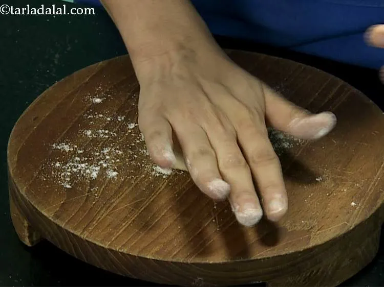 Step 12 – Sprinkle a little whole wheat flour on the rolling board. Take one portion of dough, …