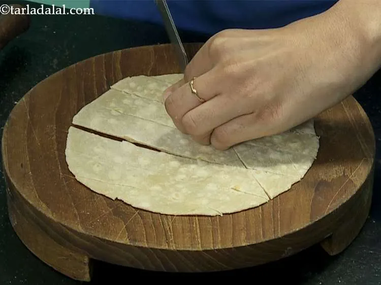 Step 16 – Place the half-cooked tortilla on a clean, dry surface. Cut into small equal diamond shaped …