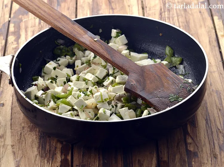 Step 35 – Put a portion of the paneer filling on one side of the tortilla.