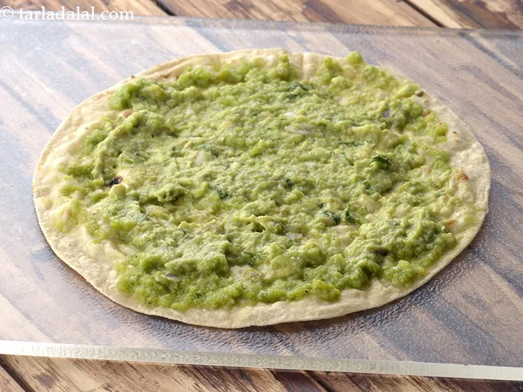 Step 34 – Spread 1 tbsp of <a href="https://www.tarladalal.com/guacamole-1239r">guacamole</a>&nbsp;evenly over it.