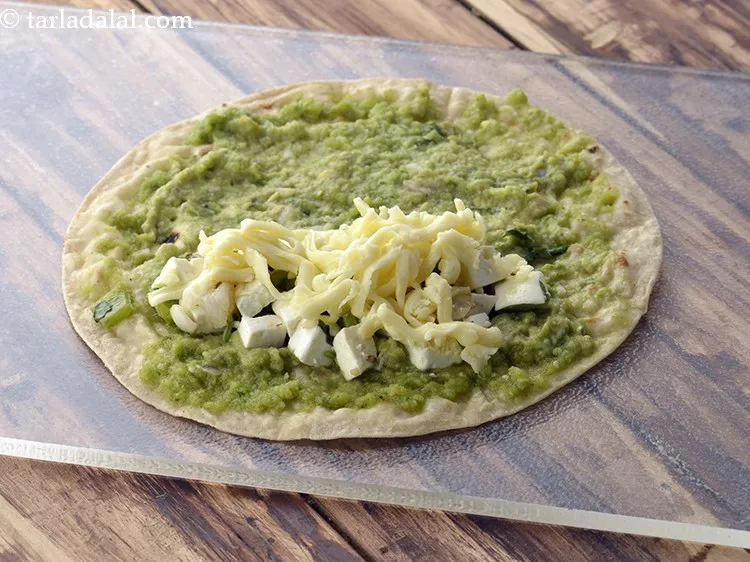 Step 36 – Sprinkle 1 tbsp of <a href="https://www.tarladalal.com/glossary-grated-processed-cheese-868i">grated processed cheese</a>&nbsp;evenly over it.