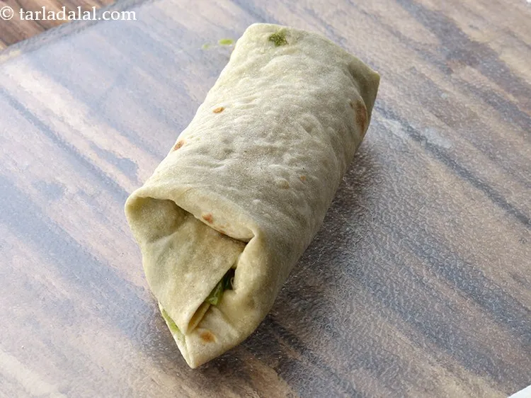 Step 37 – To roll, fold the two opposite ends of the tortilla over the stuffing. Start rolling …