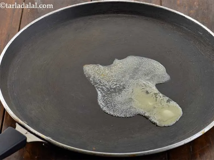 Step 38 – Heat 1 tsp of <a href="https://www.tarladalal.com/glossary-butter-makhan-233i">butter</a>&nbsp;on a non-stick tava (griddle).