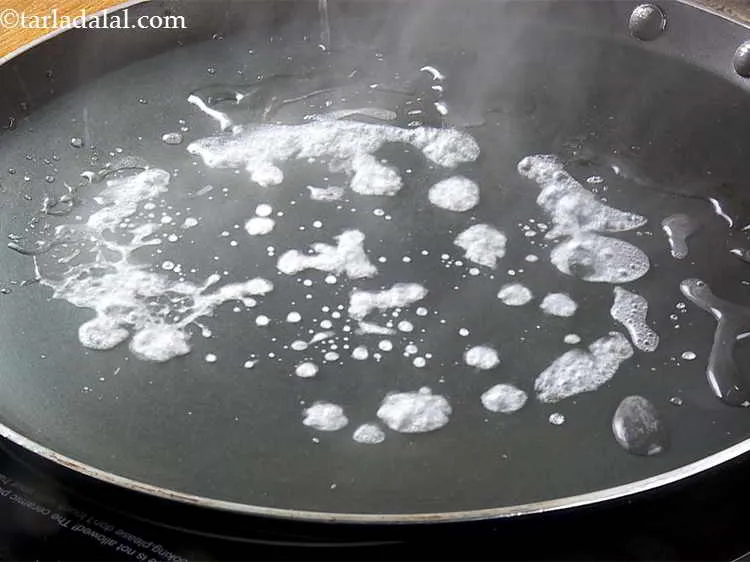 Step 13 – Heat a non-stick tava (griddle), sprinkle a little water on it (it should sizzle immediately).