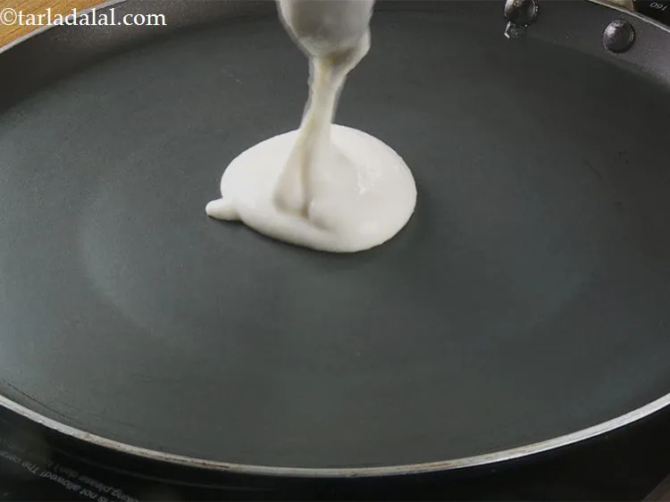 Step 15 – Pour a ladleful of the batter (approx. &frac14; cup) on the tava (griddle). If your …