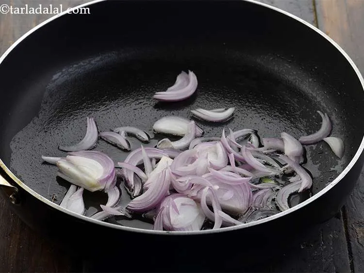 Step 20 – Once the oil is hot, add 1/2 cup&nbsp;thinly&nbsp;<a href="https://www.tarladalal.com/glossary-sliced-onions-745i">sliced onions</a>.