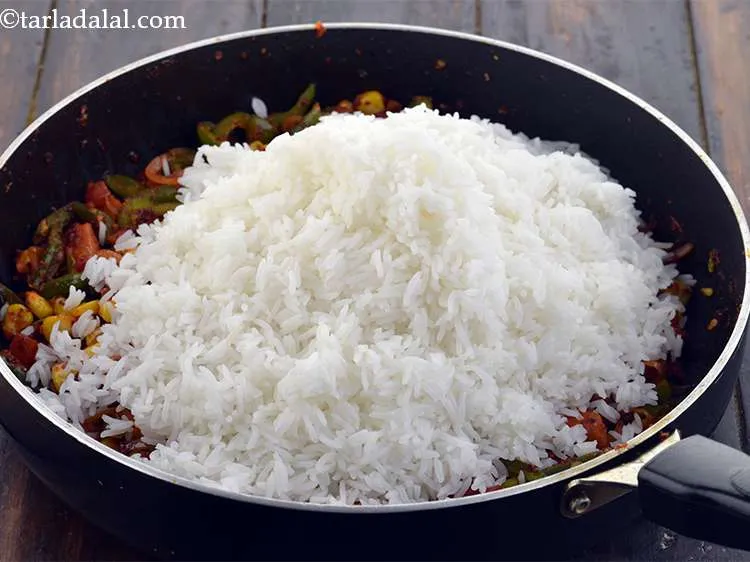 Step 29 – Now add 3 cups&nbsp;<a href="https://www.tarladalal.com/glossary-soaked-and-cooked-long-grain-rice--1904i">cooked rice (chawal)</a>. Ensure that cooked rice does not have any …
