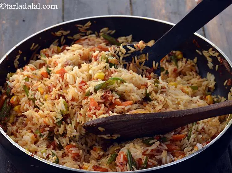 Step 31 – Toss gently to incorporate or mix&nbsp;<strong>Veg</strong>&nbsp;<strong>Mexican Fried Rice&nbsp;</strong>well using two spoons.