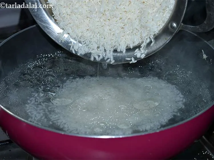 Step 33 – Add the rice to the boiling water and mix well.