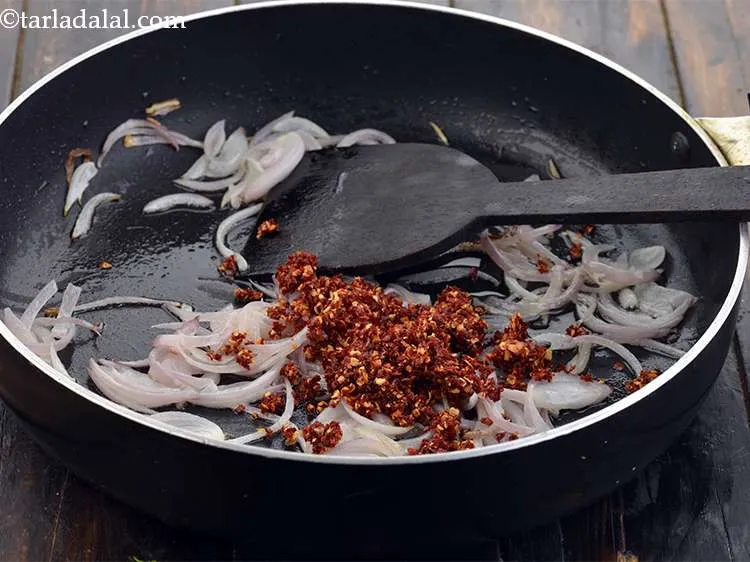 Step 46 – Add the prepared chilli-garlic paste to the onions.