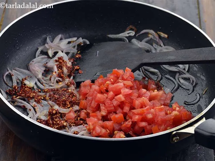 Step 22 – Then add 1/2 cup&nbsp;finely&nbsp;<a href="https://www.tarladalal.com/glossary-chopped-tomatoes-779i">chopped tomatoes</a>. They give a slight tangy taste to the rice.