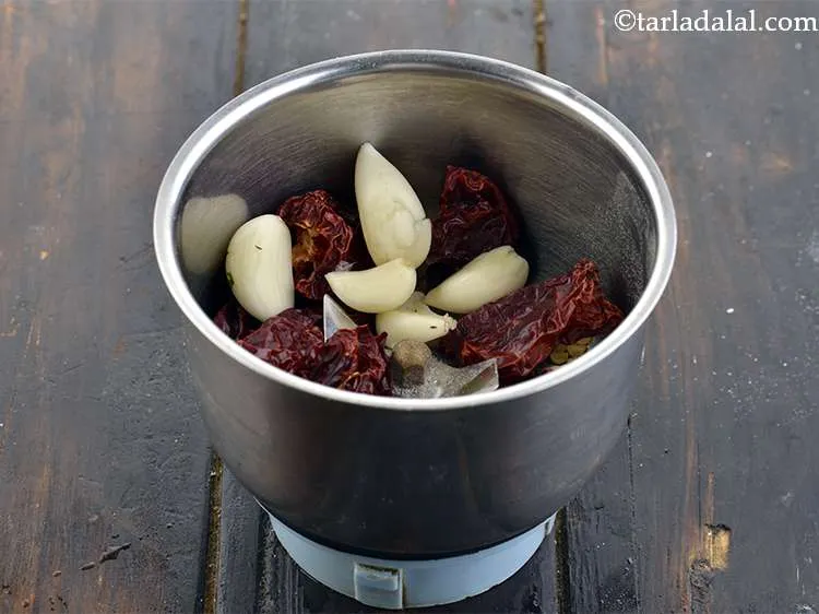 Step 15 – To this, add 4 to 5&nbsp;<a href="https://www.tarladalal.com/glossary-garlic-cloves-1857i">garlic (lehsun) cloves</a>.