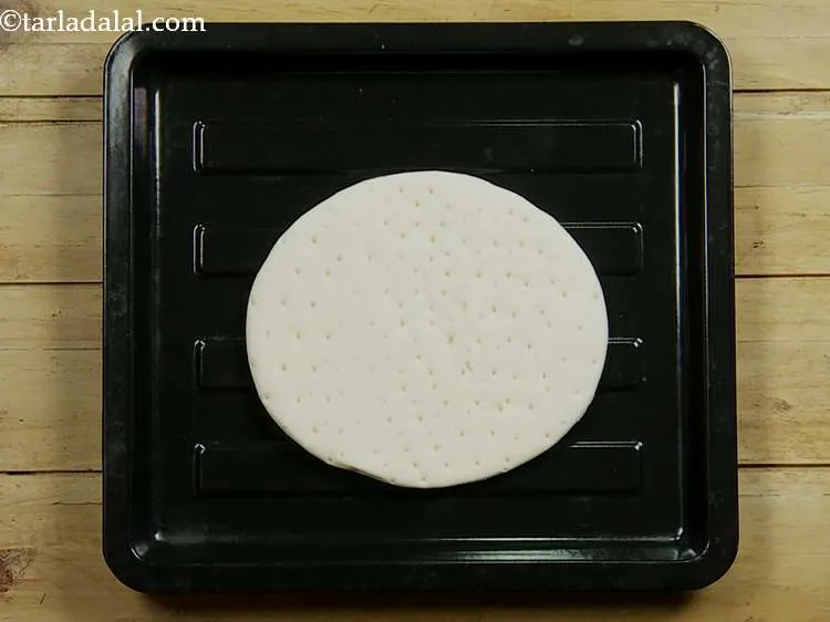 Step 8 – Arrange the pizza base on a clean, dry surface. Here we have used ready-made pizza …