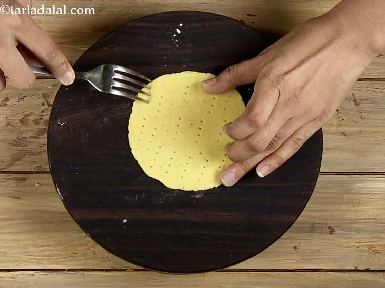 Step 56 – Prick the tortilla evenly with a fork. This is done to avoid puffing up of …