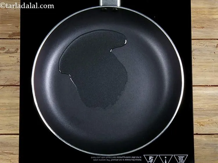 Step 18 – Heat the oil in a broad non-stick pan.