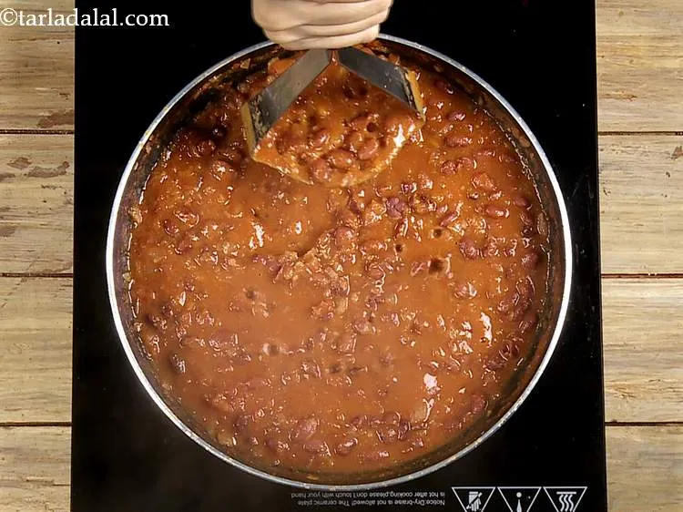 Step 30 – Also mash it lightly using a potato masher to break the beans apart a little …