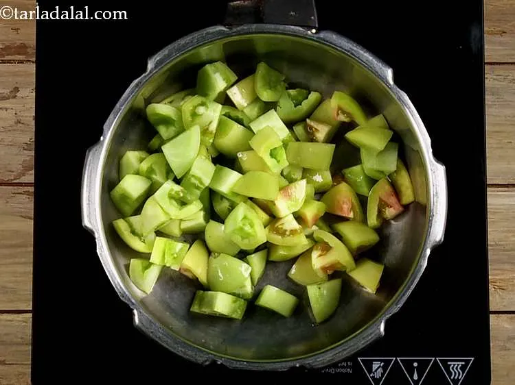 Step 33 – Take a pressure cooker and add the green tomatoes to it. Green tomatoes, also known …