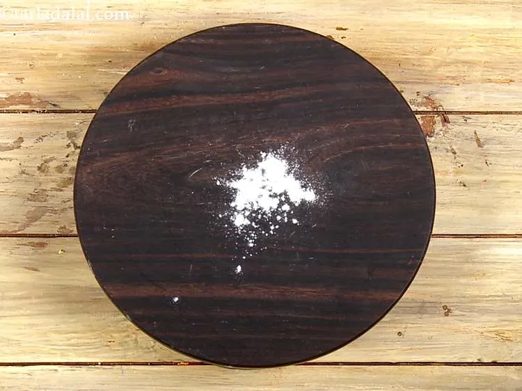 Step 7 – Take a rolling board and sprinkle a little flour on it.
