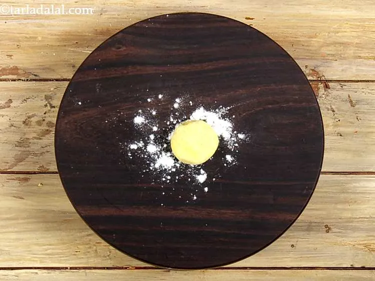 Step 8 – Take a portion of the dough and flatten it on the rolling board.
