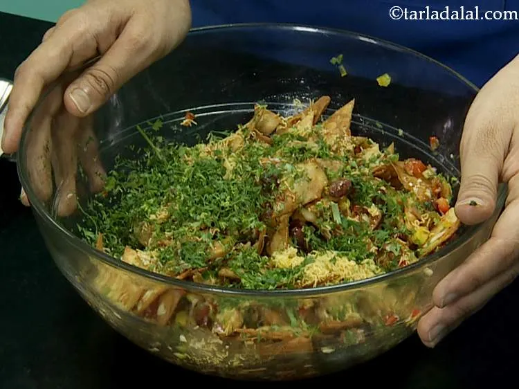 Step 26 – After adding the chips garnish with sev and coriander.