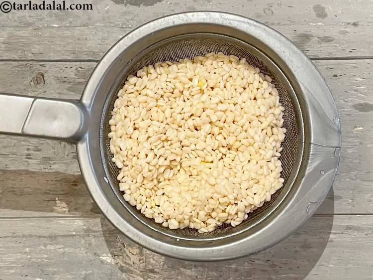 Step 21 – Strain the urad dal with a sieve.