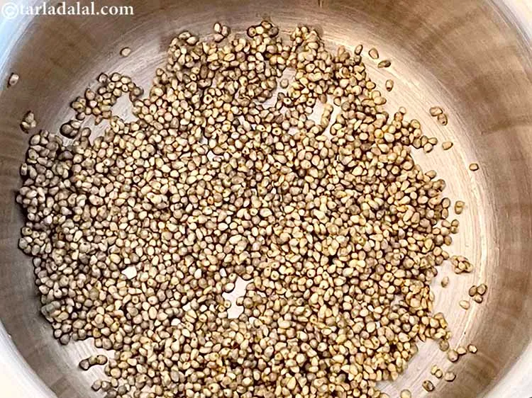 Step 10 – <meta charset="UTF-8" />In a pressure cooker add the soaked whole bajra.&nbsp;