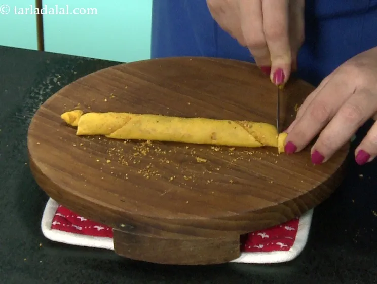 Step 50 – Trim a small portion from both the sides of the cylindrical roll and discard them.