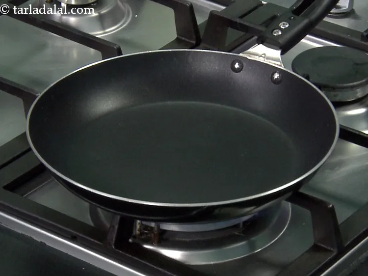 Step 14 – For the masala, heat a broad non-stick pan.