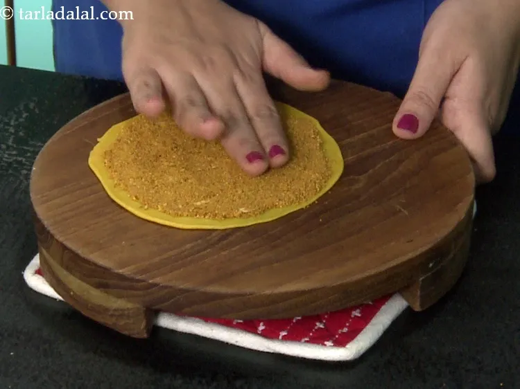 Step 61 – Pat the masala lightly with your fingers while leaving a little space at the circumference. …