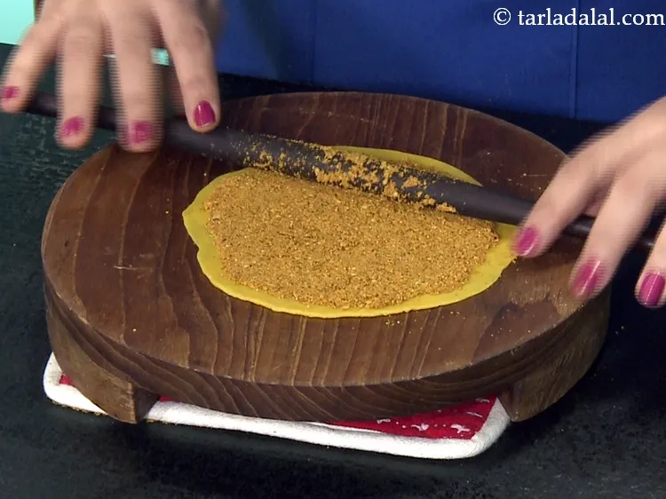 Step 44 – Gently roll over the masala evenly using a rolling pin, to ensure that the masala …