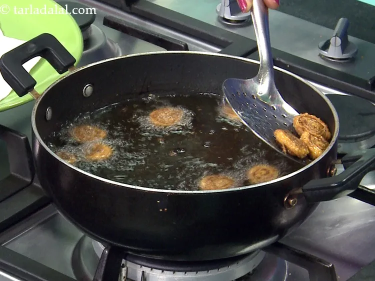 Step 65 – Do not roll and then deep-fry all the bhakarwadi. Make in batches and deep-fry in …