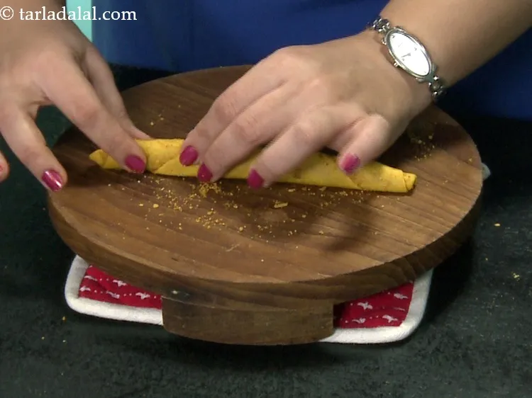 Step 49 – Gently press all over the cylindrical roll evenly so that the masala further sticks to …