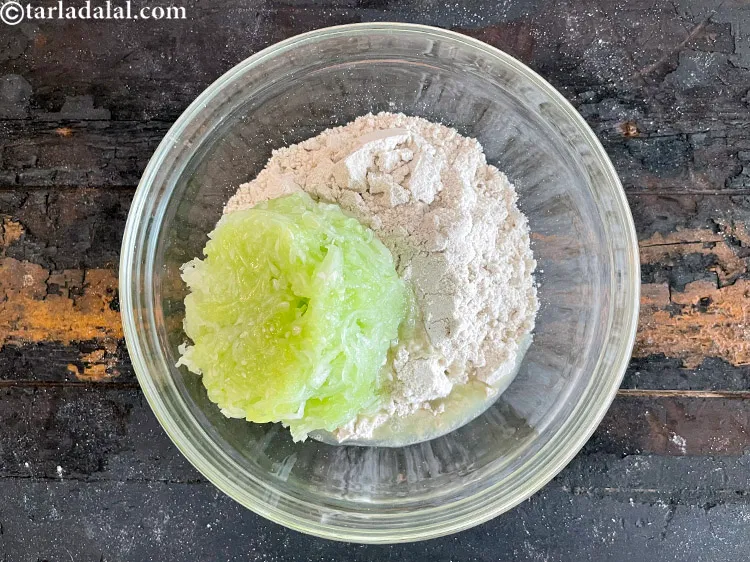 Step 14 – Add&nbsp;<meta charset="UTF-8" />1&nbsp;cup&nbsp;<a href="glossary-grated-cucumber-1058i">grated cucumber</a>.&nbsp;With that high water content,&nbsp;<a href="https://www.tarladalal.com/recipes-using-cucumber-321" target="_blank">cucumber</a>&nbsp;act as a broom for …