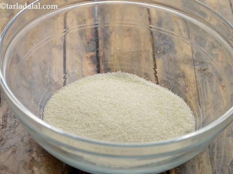 Step 2 – For making the&nbsp;<strong>Mini Rava Vegetable Pankcake</strong>, in a deep bowl, take semolina.