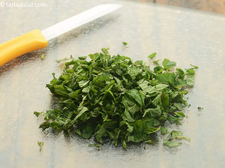 Step 16 – Place the mint leaves on a chopping board and finely chop them. Keep the mint …