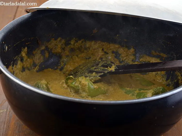 Step 32 – Add the chillies, mix well and cover with a lid and cook on a medium …