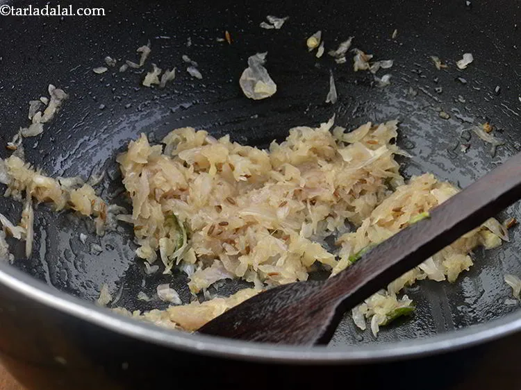 Step 24 – When the seeds crackle add the grated onions mix well and saut&eacute; on a medium …